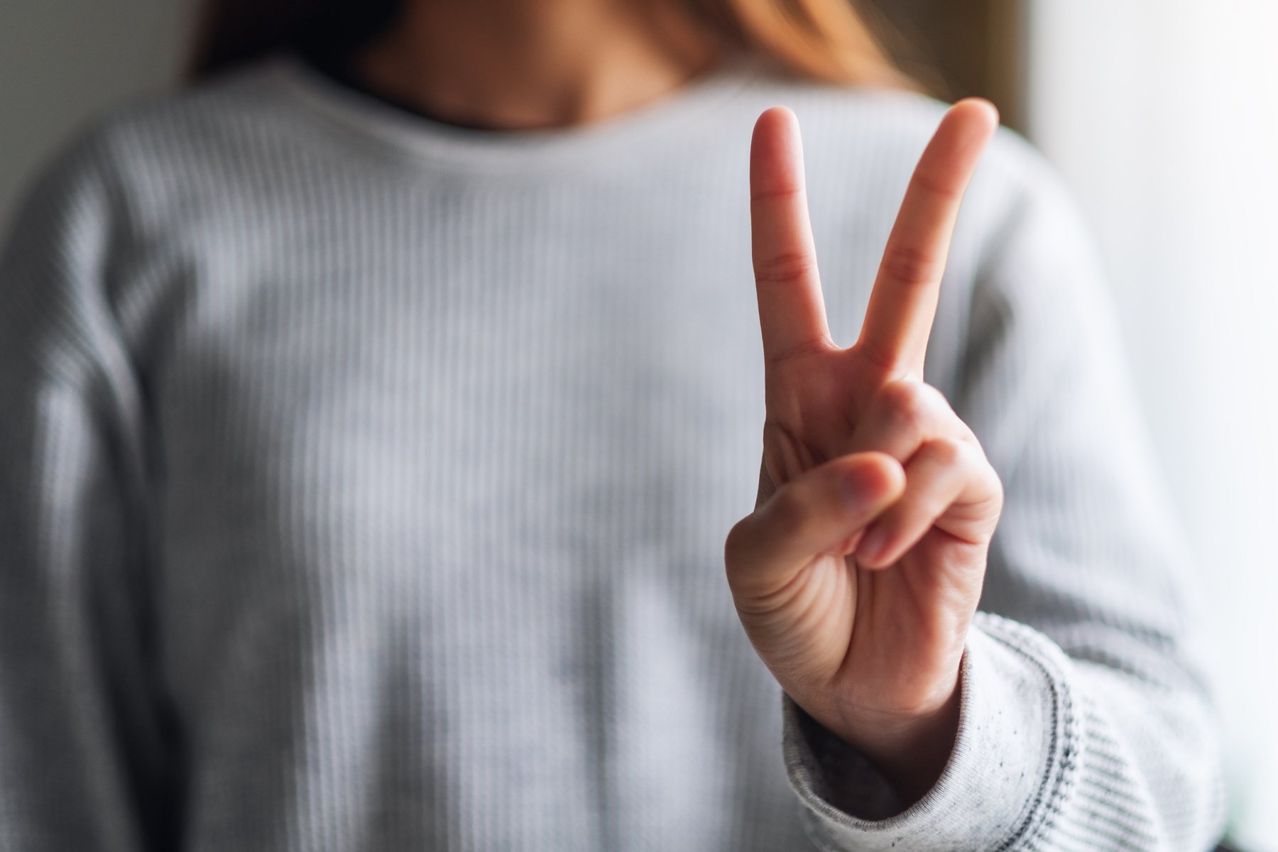 Closeup Image of a Woman Making and Showing Number Two Hand Sign